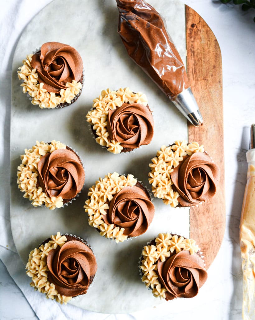 Chocolate Cupcakes on a marble board frosted with Vegan Chocolate Buttercream Frosting