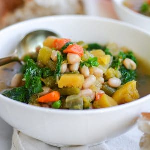 close up of Vegan Acorn Squash stew in a white bowl