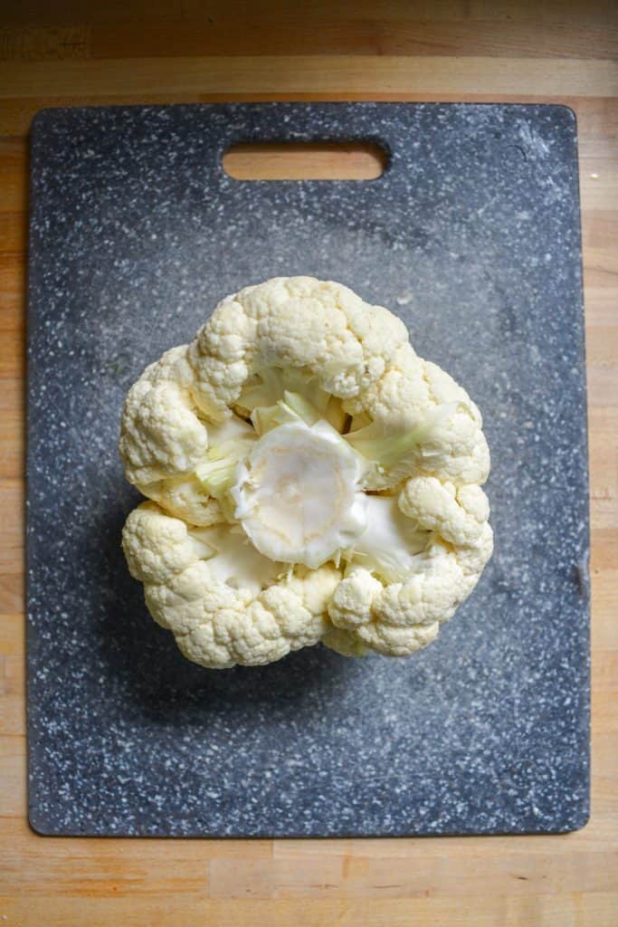 A head of cauliflower on a cutting board