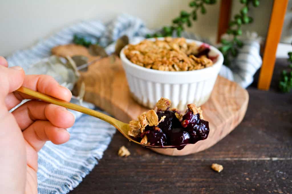Close up of bite of healthy berry crisp for one