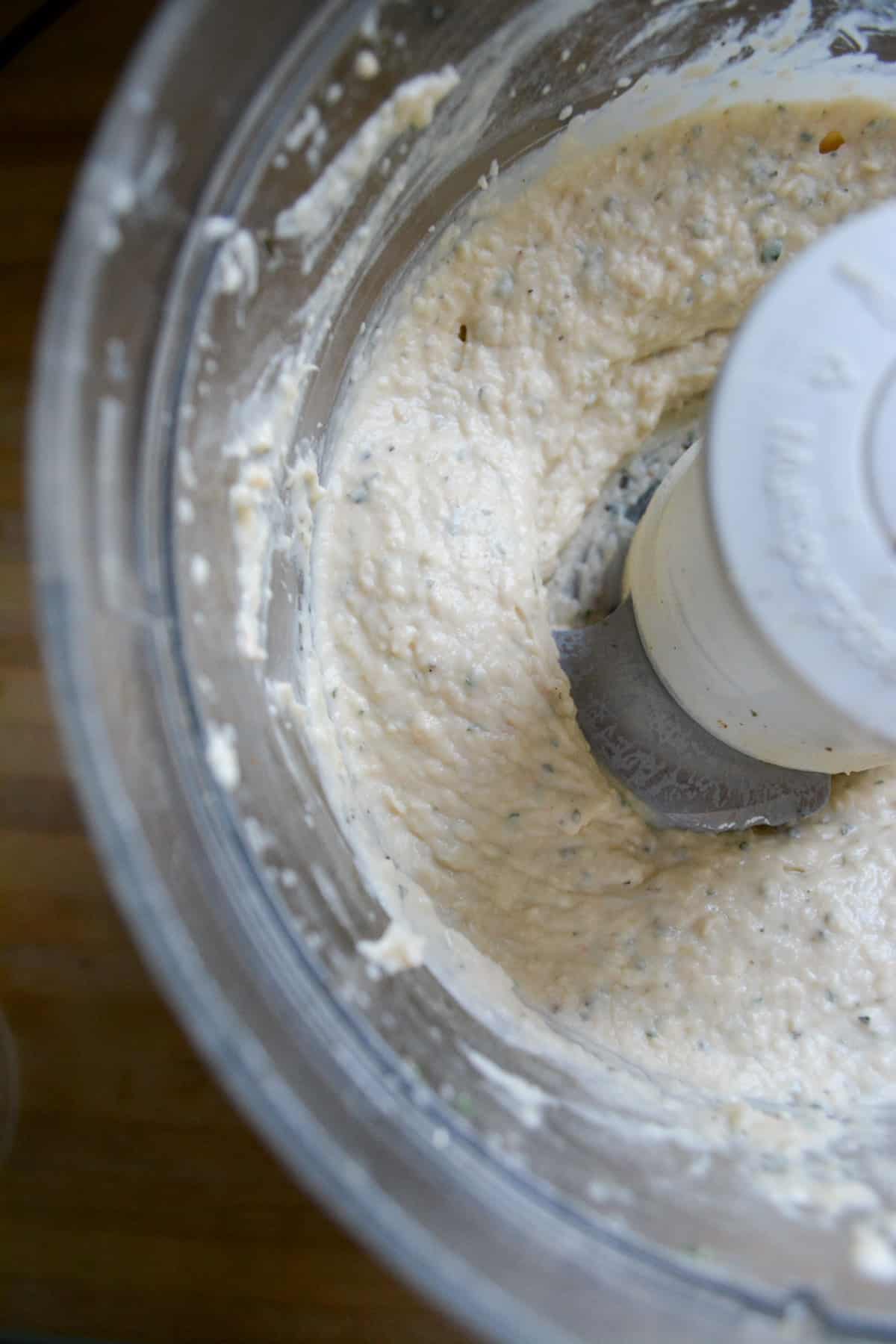 Finished vegan garlic and herb white bean dip in the food processor.
