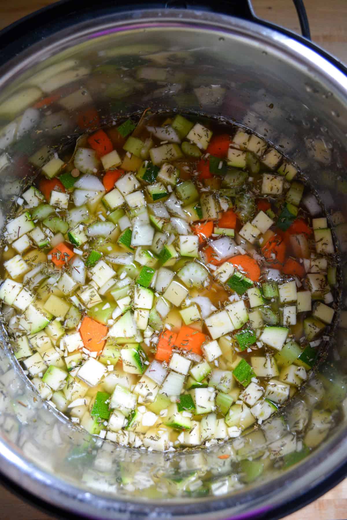 Instant Pot Lentil Soup ingredients in the pot and ready to cook.