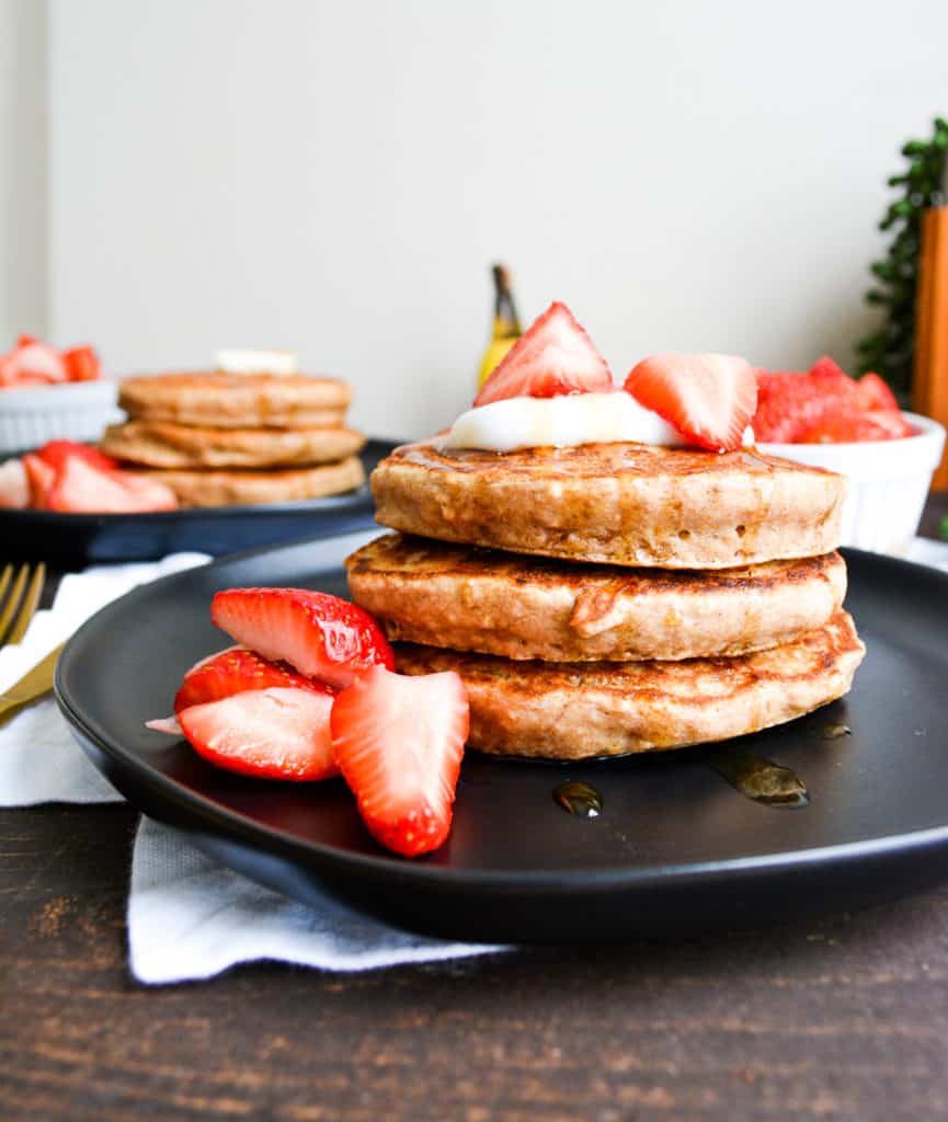 Portrait of stacked east banana bread pancakes with strawberries