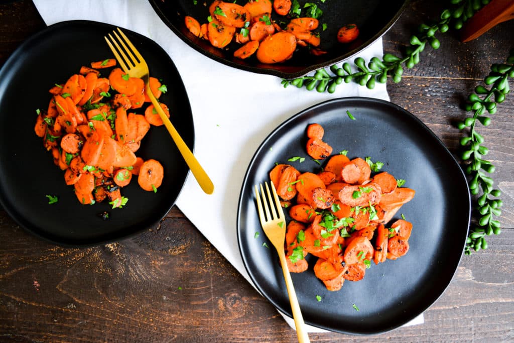 Carrots on two black plates