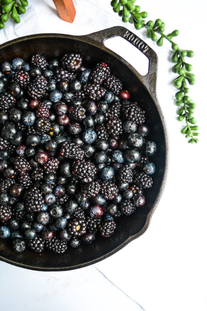 Blackberries and blueberries in a cast iron skillet