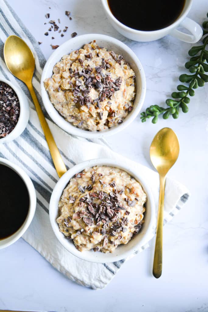 2 bowls of peanut butter cookie dough overnight oats topped with cacao nibs