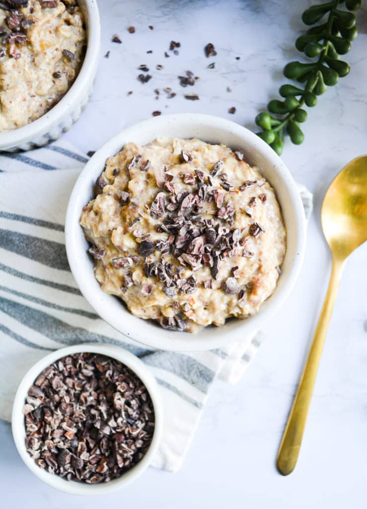 Close up of peanut butter cookie dough overnight oats topped with cacao nibs