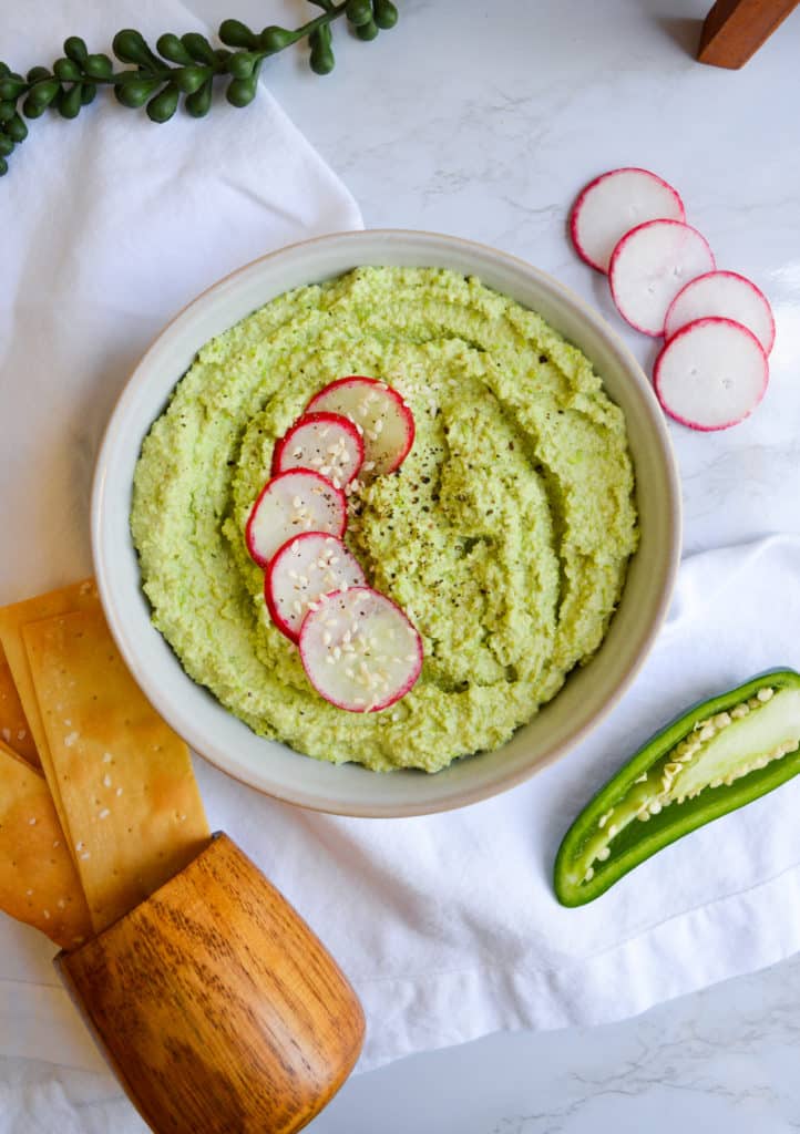 Spicy Edamame Hummus in a bowl with radish slices