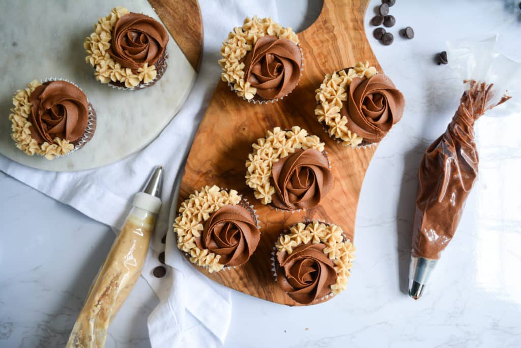 One-Bowl Chocolate Cupcakes with chocolate buttercream on a wooden board