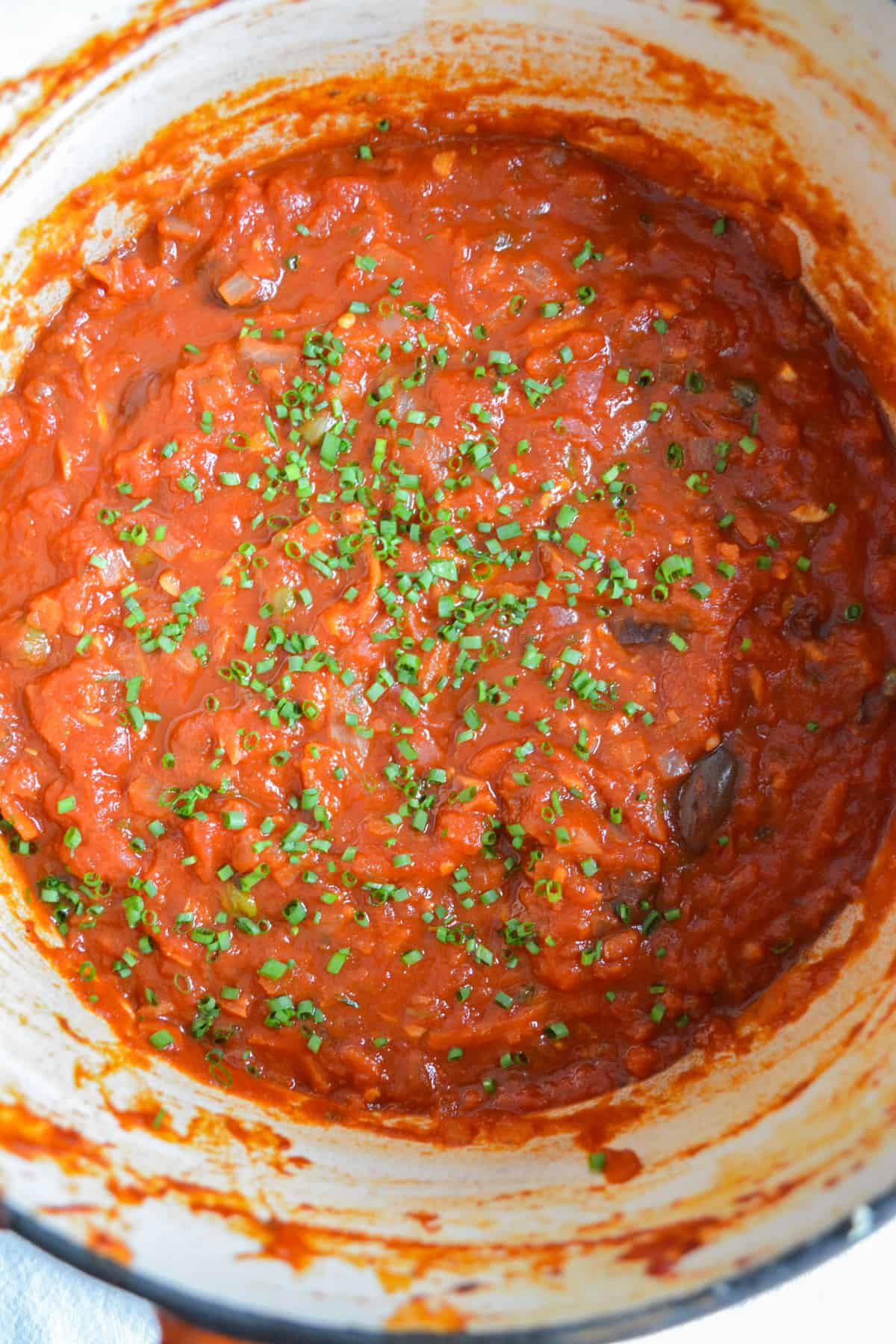 Overhead photo os vegan puttanesca sauce in a pot.