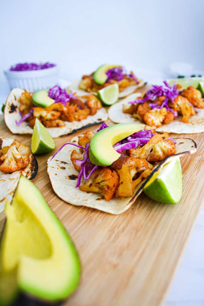 Portrait of Agave Chipotle Cauliflower Tacos on a wooden  cutting board