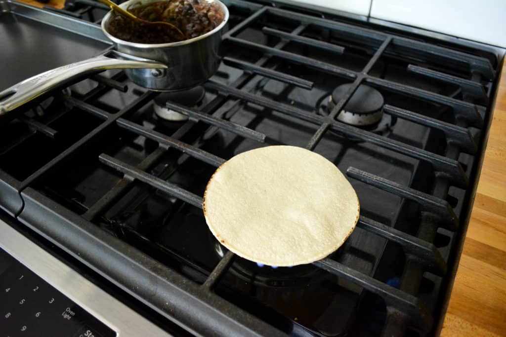 Heating a tortilla on a gas stove