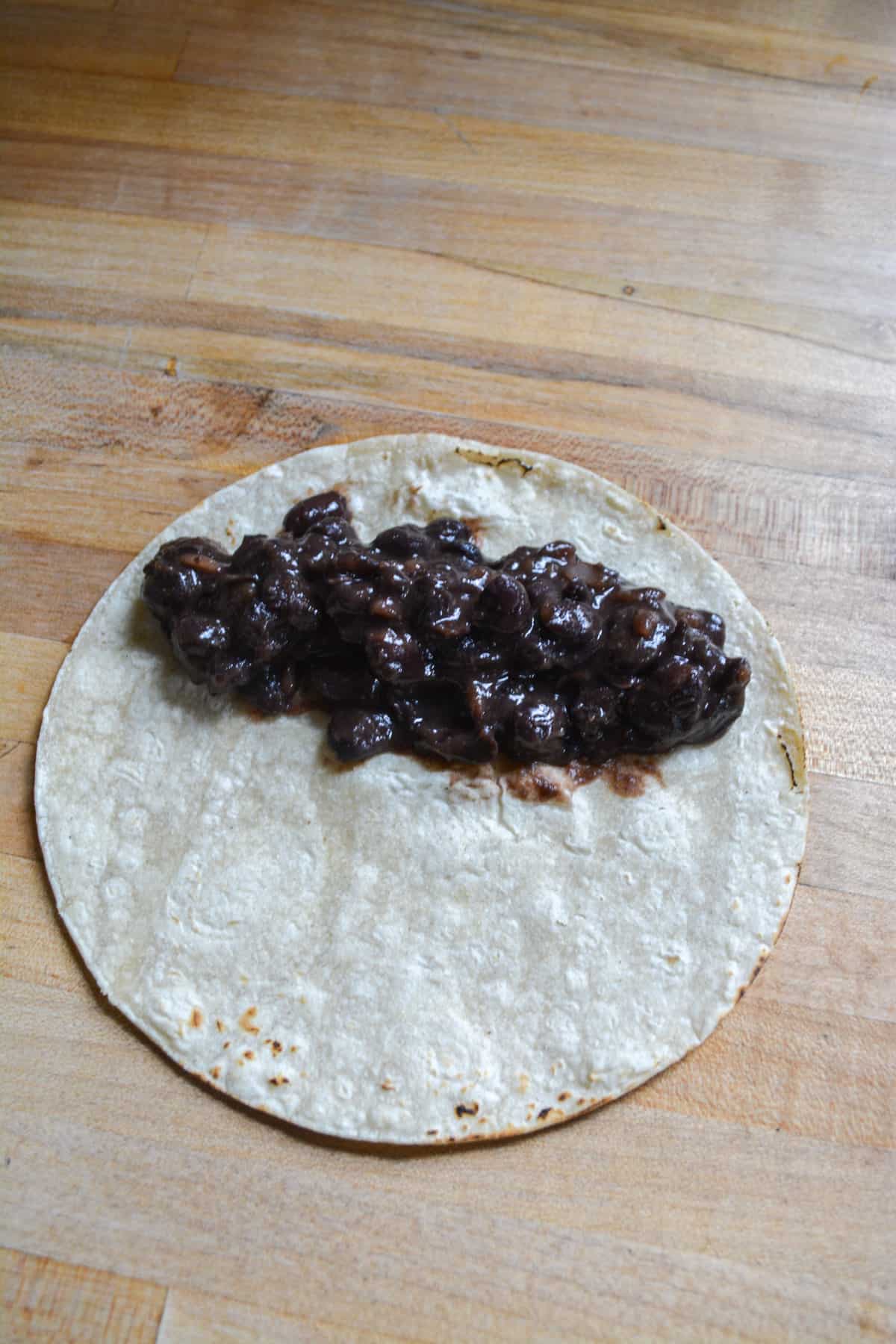 Black beans on a corn tortilla.