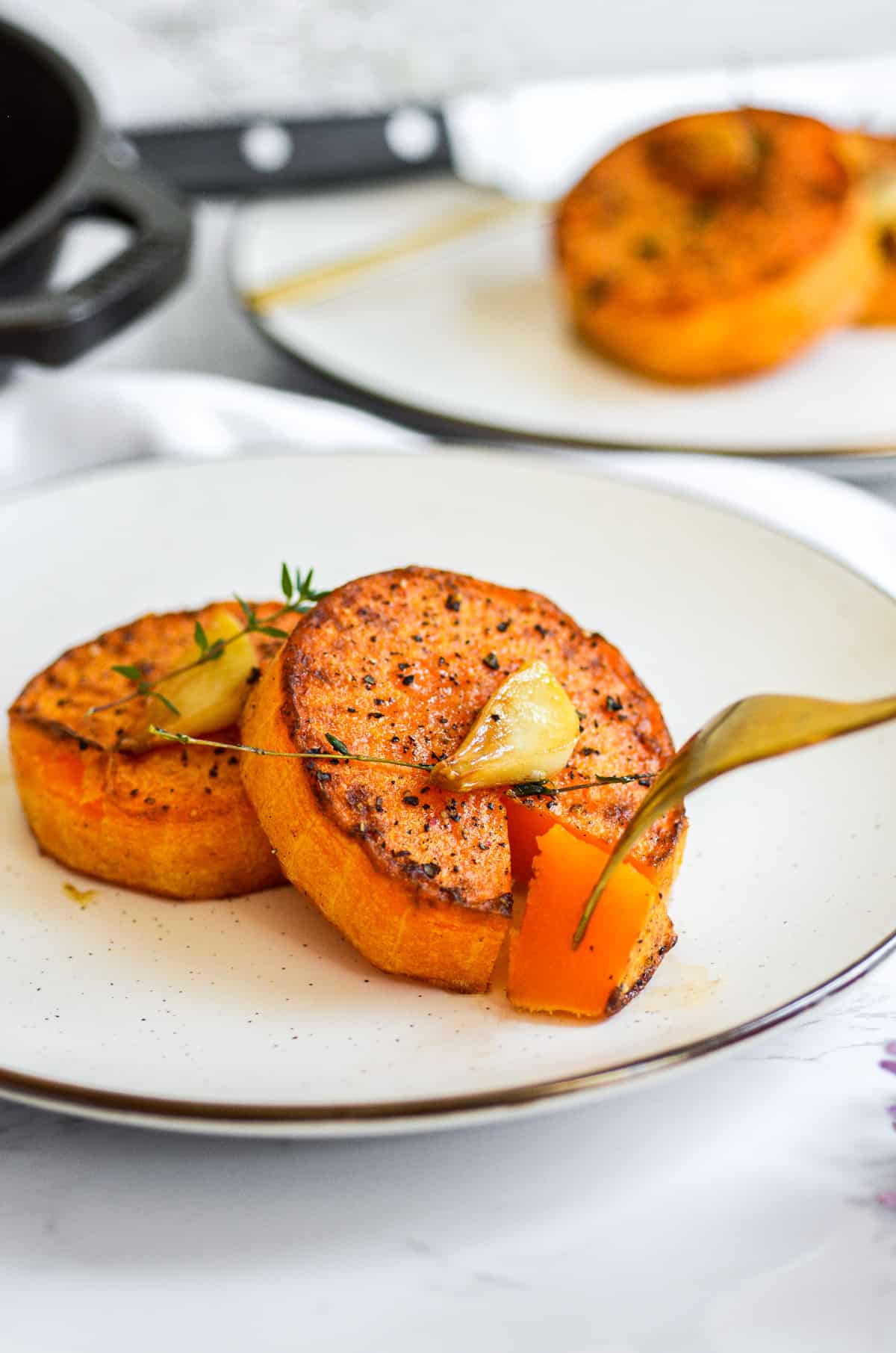 Fork taking a piece of a butternut squash steak