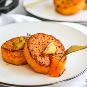 Fork taking a piece of a butternut squash steak