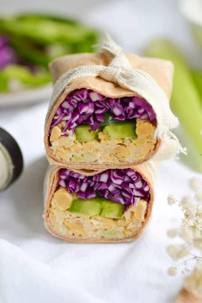 close up of a vegan chickpea salad wrap that has purple cabbage and green bell pepper in it