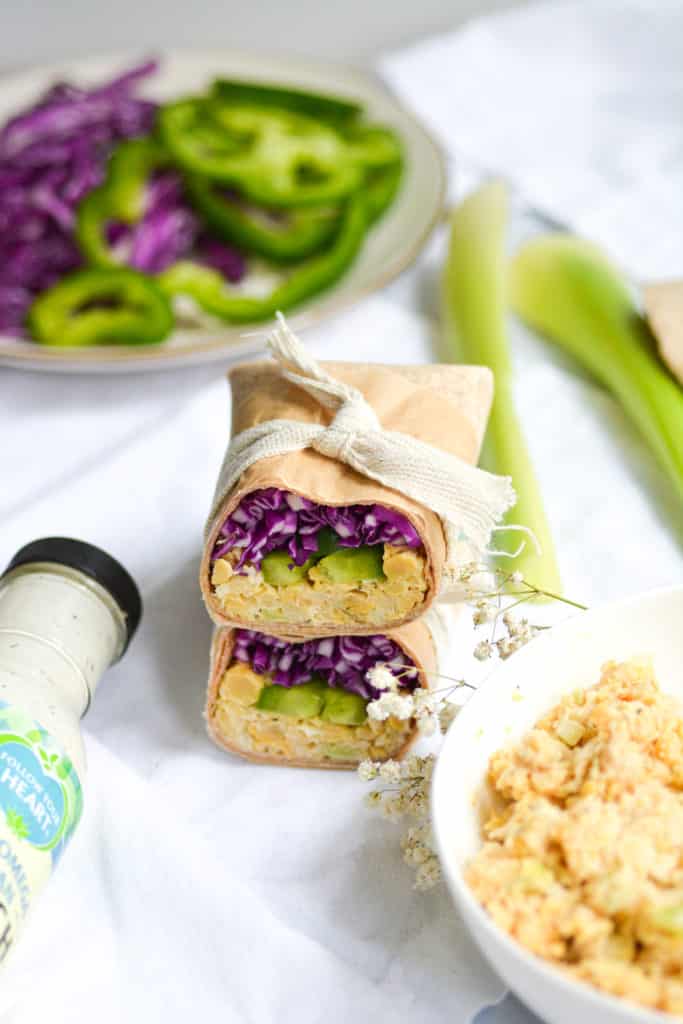 chickpea salad in a tortilla with purple cabbage on a white cloth