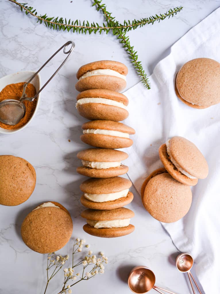 One-Bowl Chai Spiced Whoopie Pies filled with vanilla buttercream and lined up.