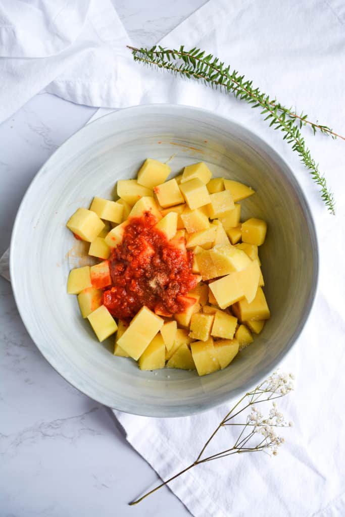 Bowl of diced potatoes with harissa