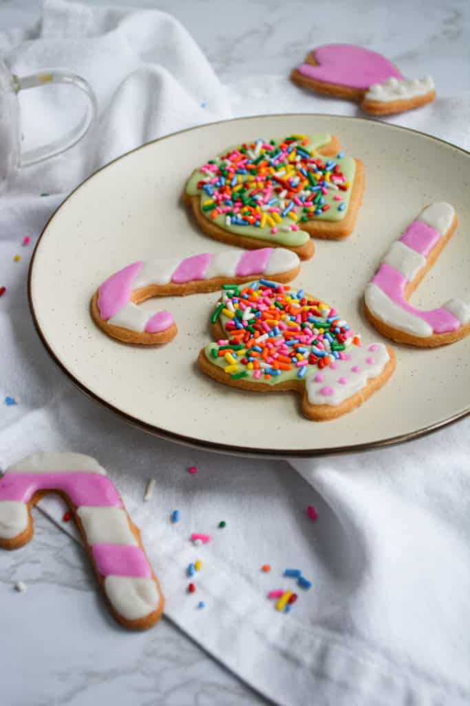Vegan Cut-Out Holiday Cookies decorated with royal icing on a plate
