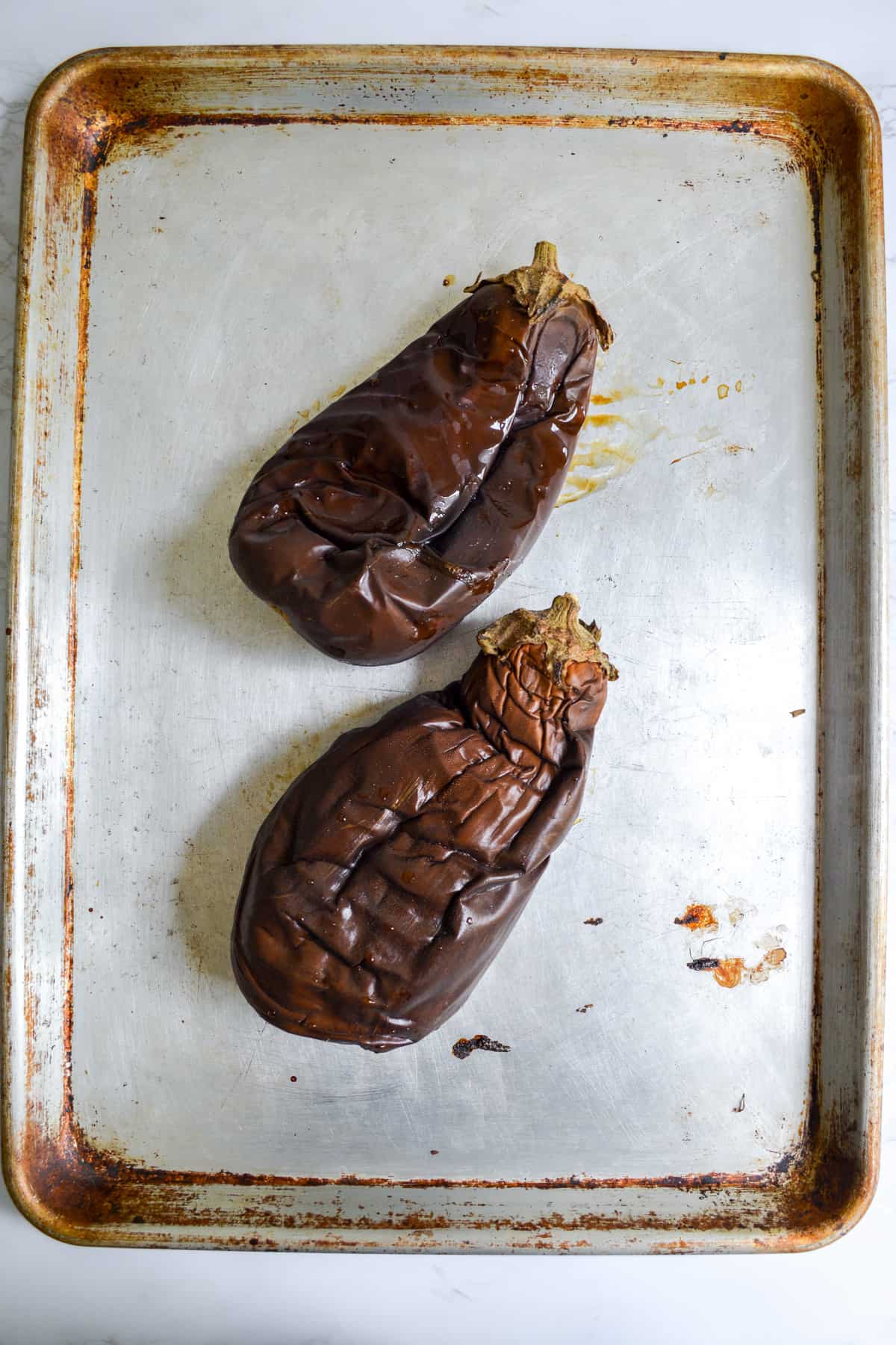 Roasted eggplants on a baking sheet