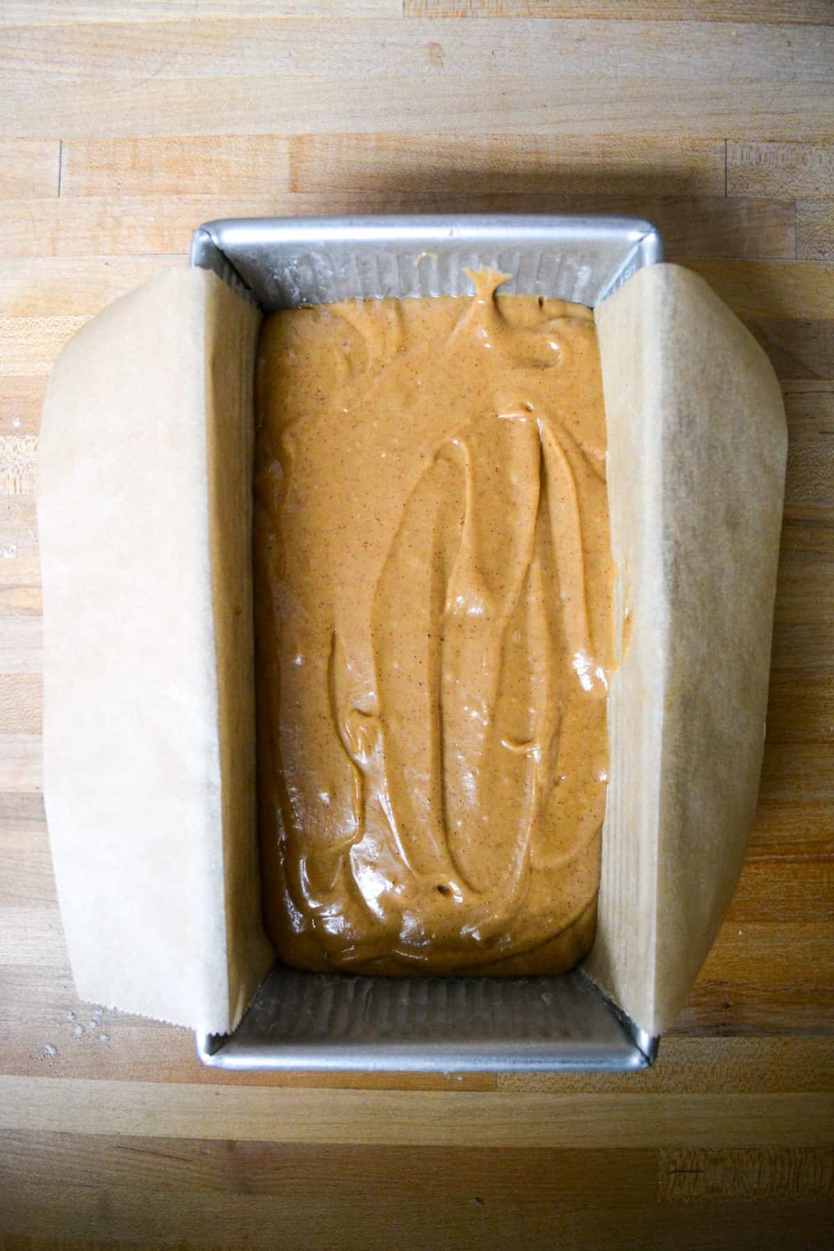 Overhead photo of vegan gingerbread loaf cake in a loaf pan.