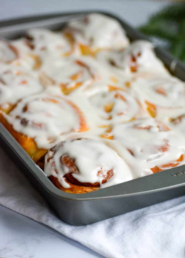 pan of cinnamon buns with cream cheese frosting