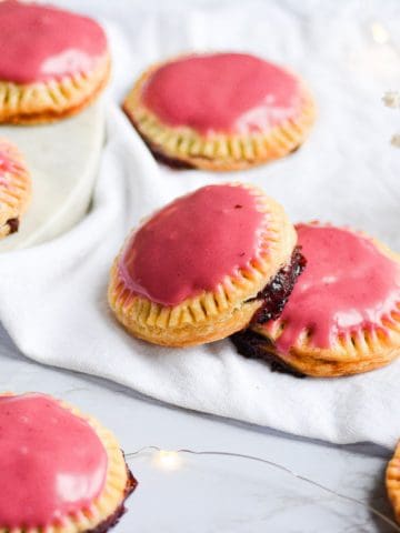 Vegan pop tarts glazed with a pink glaze on a white napkin