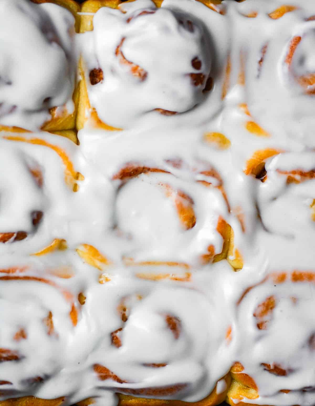 Overhead shot of frosted cinnamon rolls without eggs.