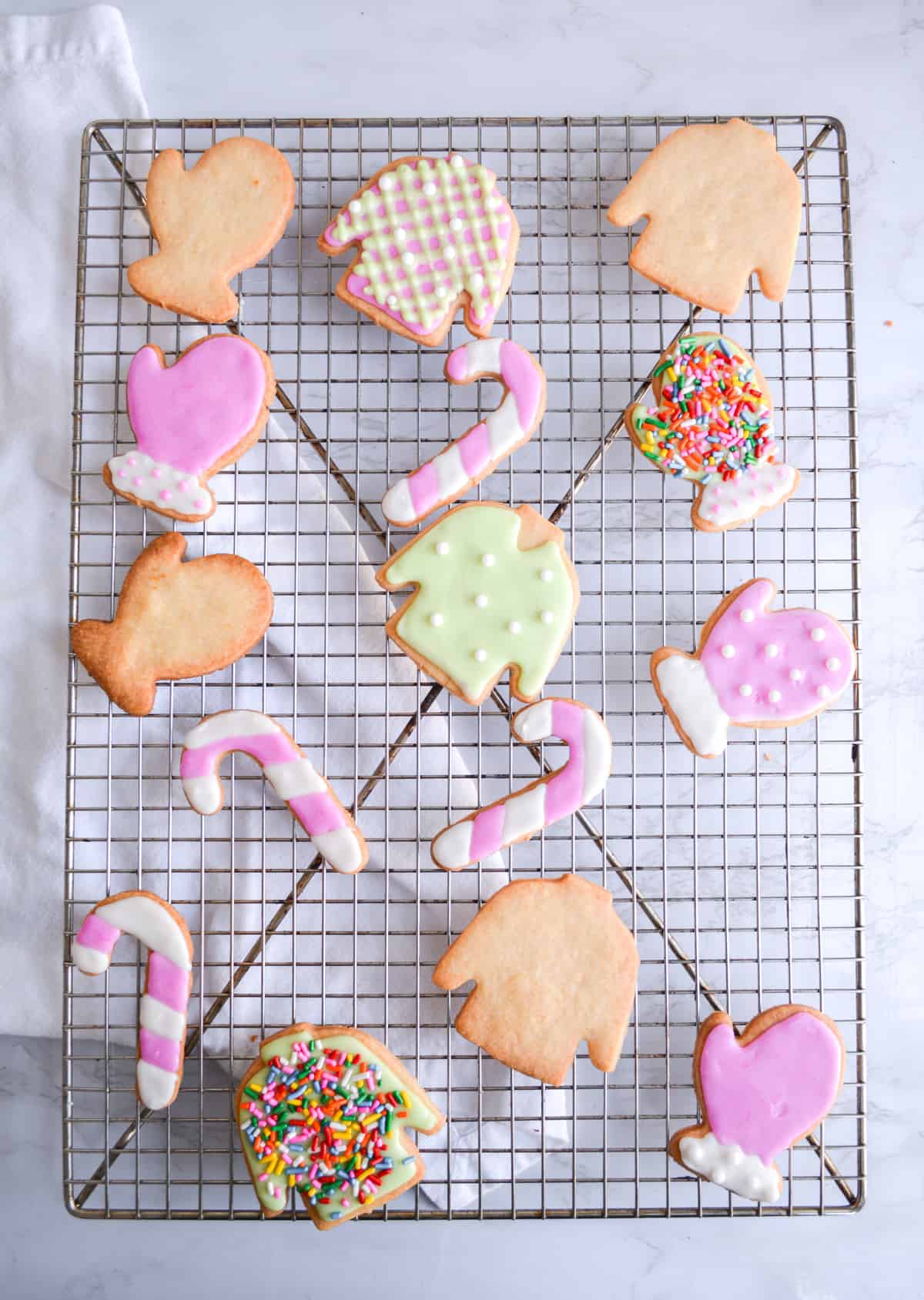 Vegan Holiday Cookies being decorated while on a wire racl