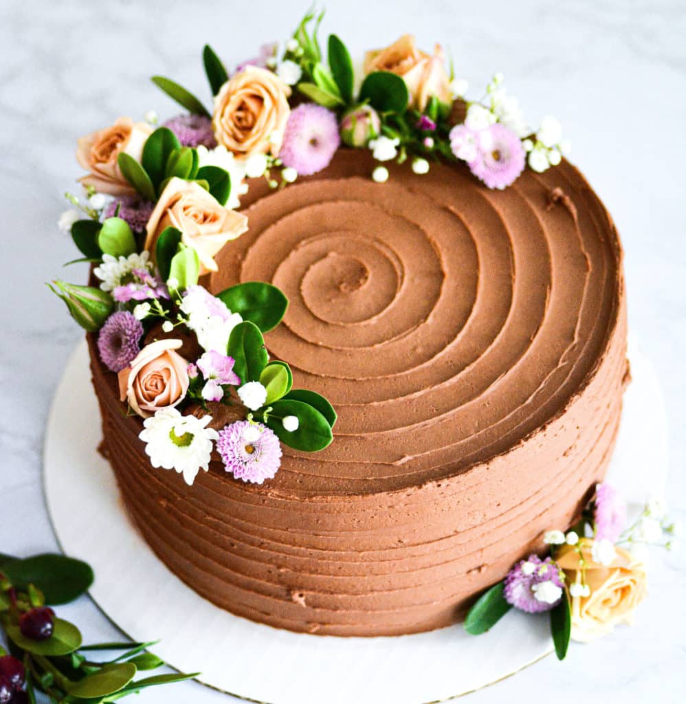 Chocolate vegan wedding cake with flowers for a boston wedding