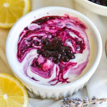 Blueberry compote swirled with vanilla yogurt in a small ramekin.