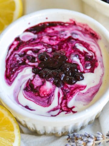 Blueberry compote swirled with vanilla yogurt in a small ramekin.