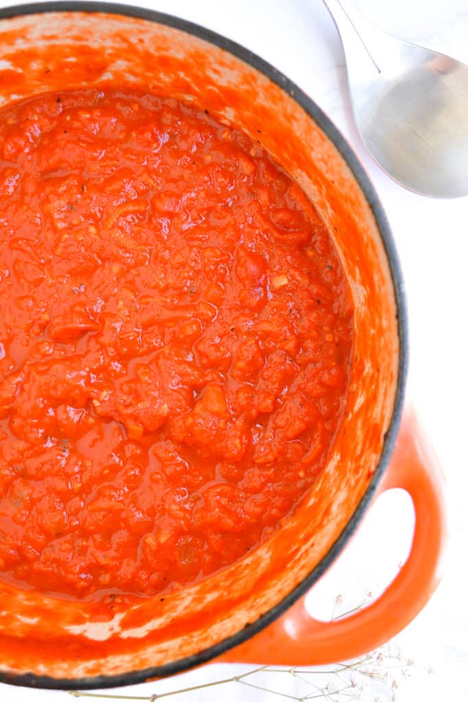 Marinara sauce in an orange dutch oven