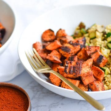 Landscape of two white bowls with tofu scramble and sweet potatoes