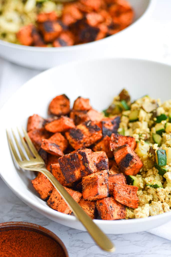 Breakfast Sweet Potatoes with tofu scramble in two white bowls