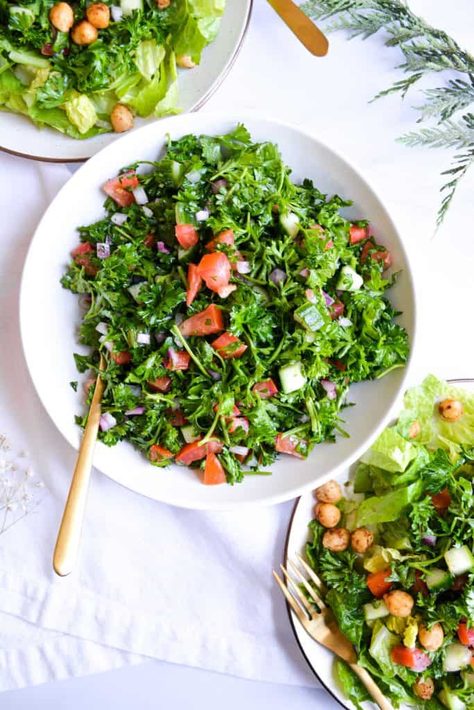 a white bowl filled with grain-free tabbouleh salad