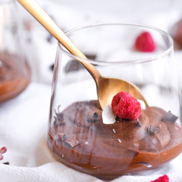 landscape of 3 glasses of one ingredient chocolate mouse in a glasss with a gold spoon
