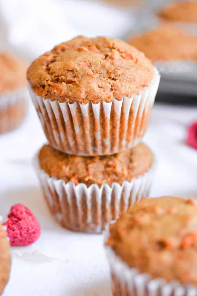 two carrot cake muffins stacked on top of each other