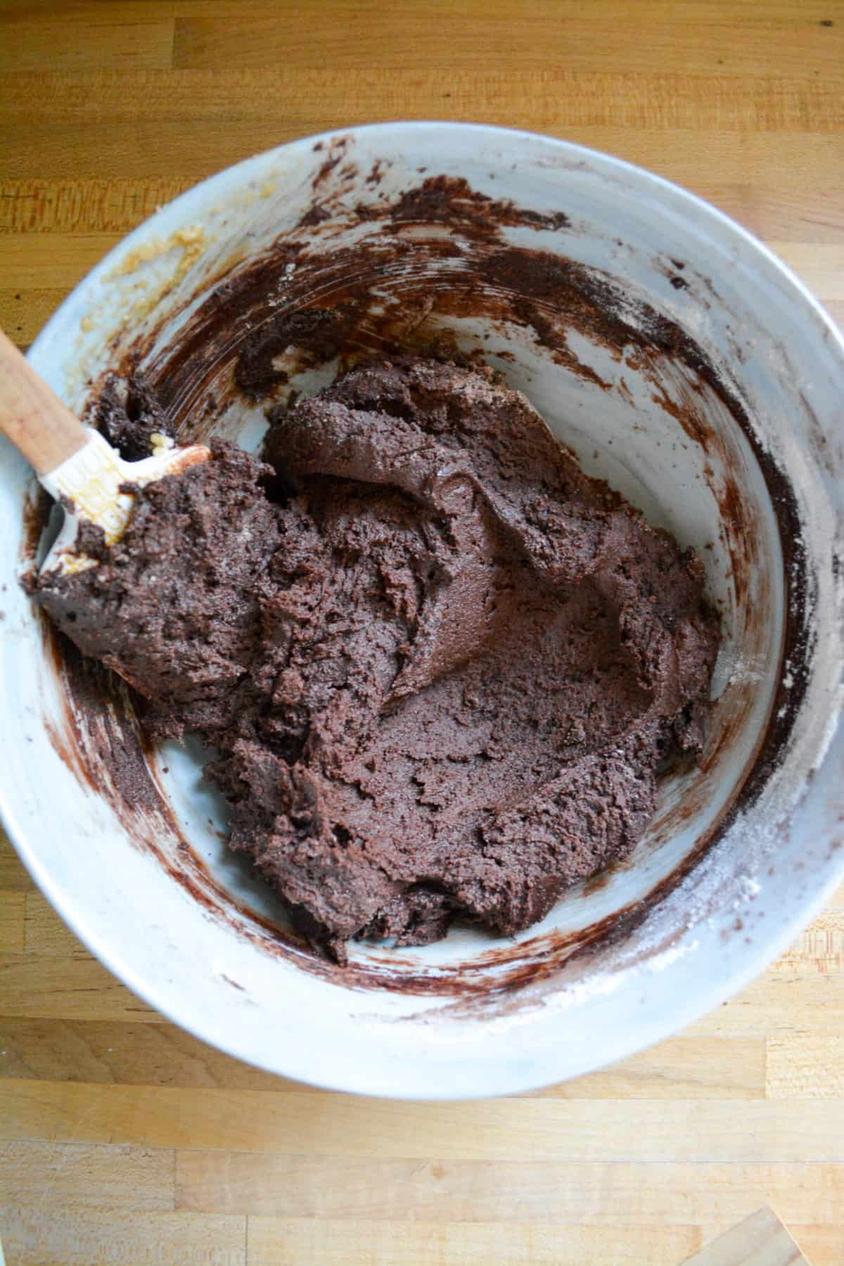 Overhead shot of dark chocolate cookie dough in a bowl.