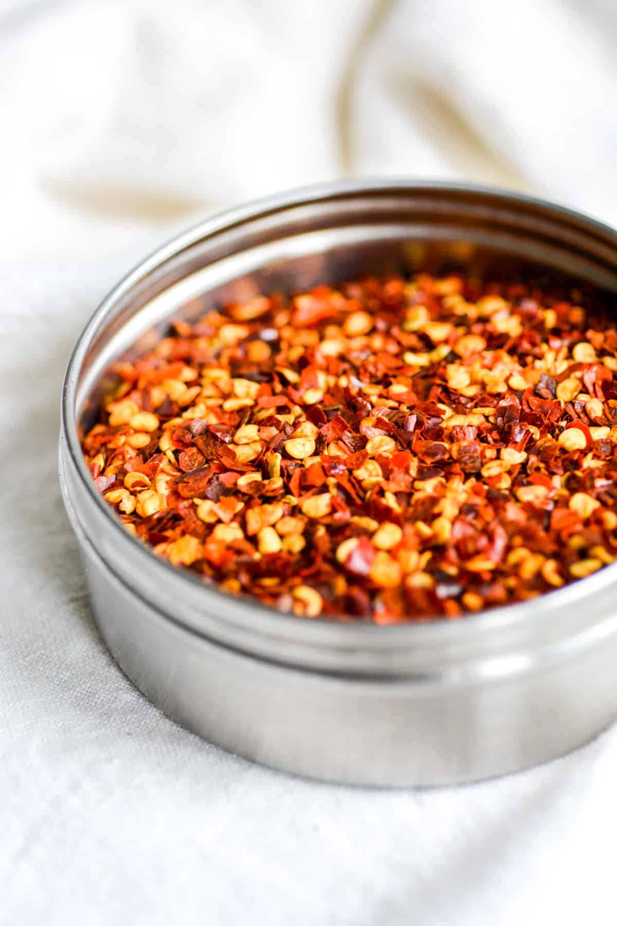 Crushed red pepper flakes in a metal container