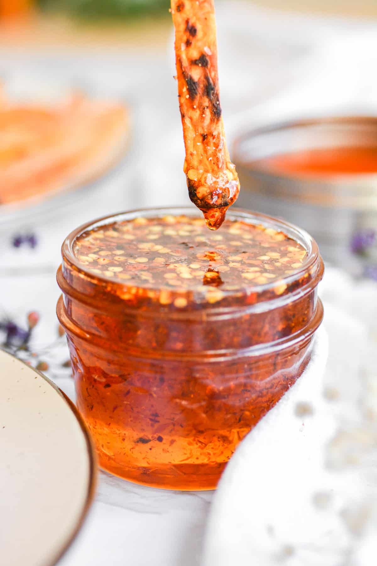 Vegan Hot honey dripping off of a sweet potato fry