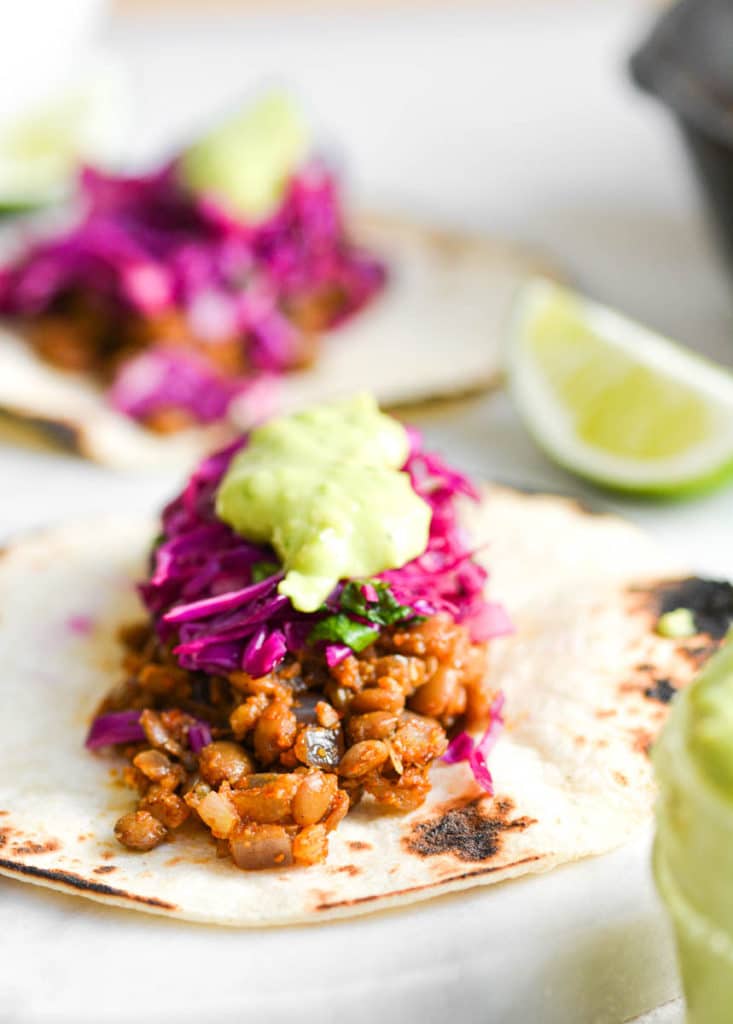 Red cabbage slaw topping a lentil taco
