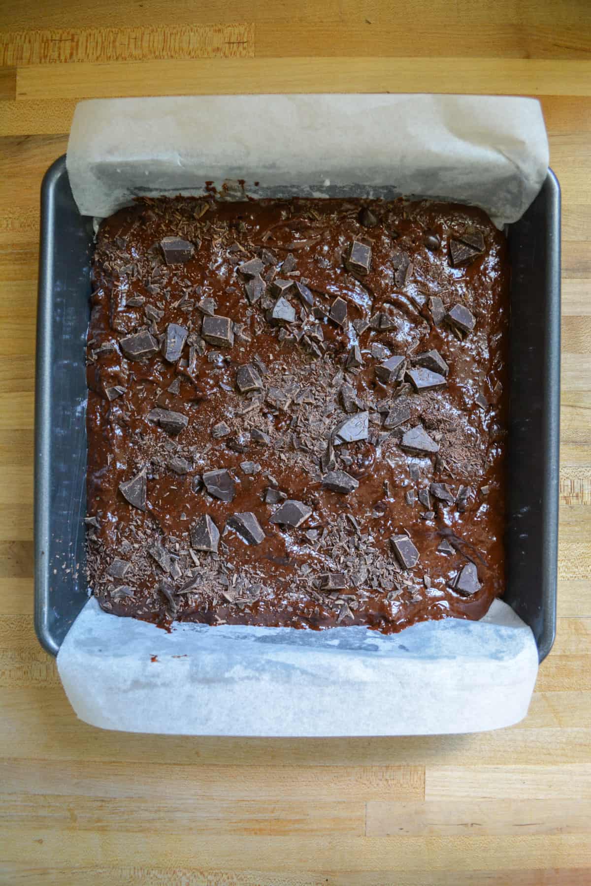 Brownie batter in a prepared baking pan.