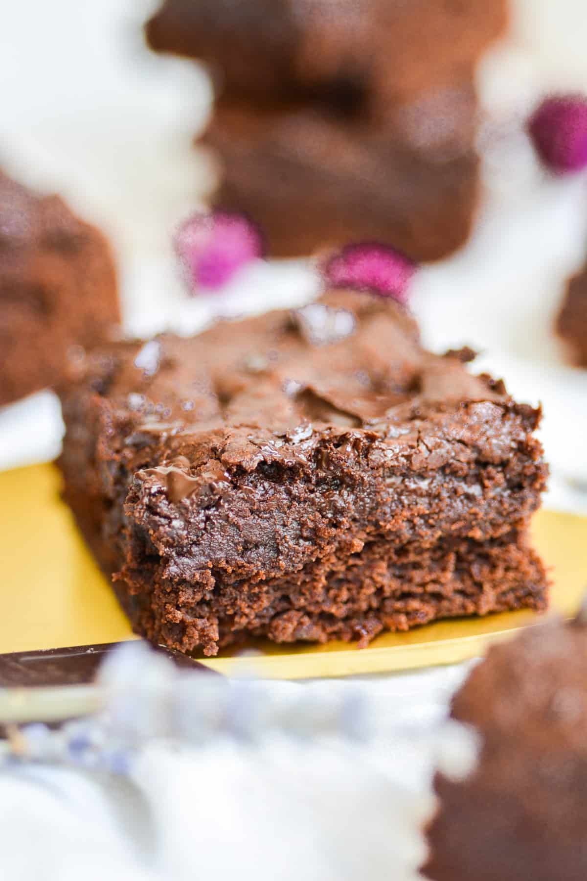 An easy dairy free fudgy chocolate brownie on a cake server