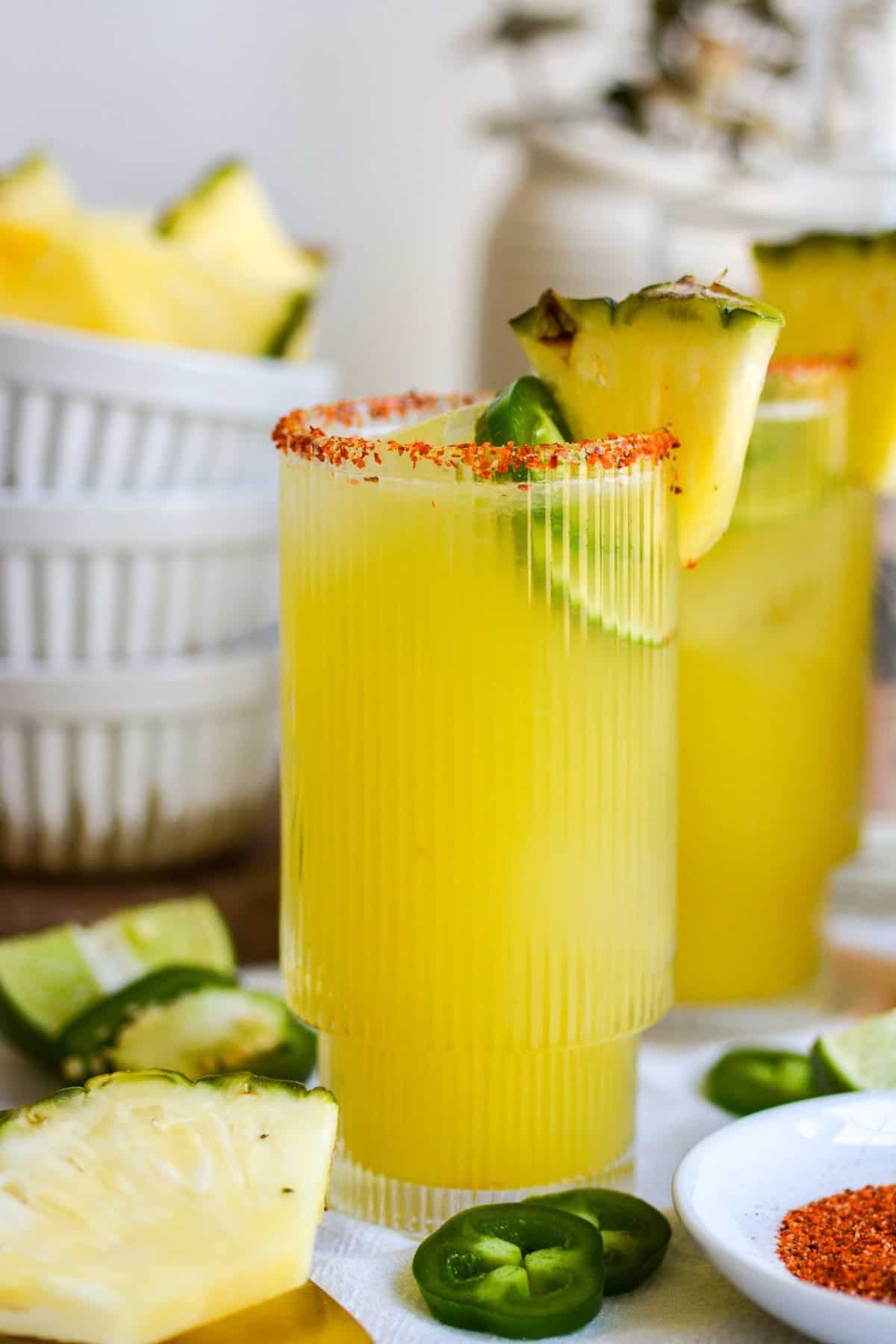 Jalapeño Pineapple Margarita in a glass garnished with a slice of pineapple and jalapeño.