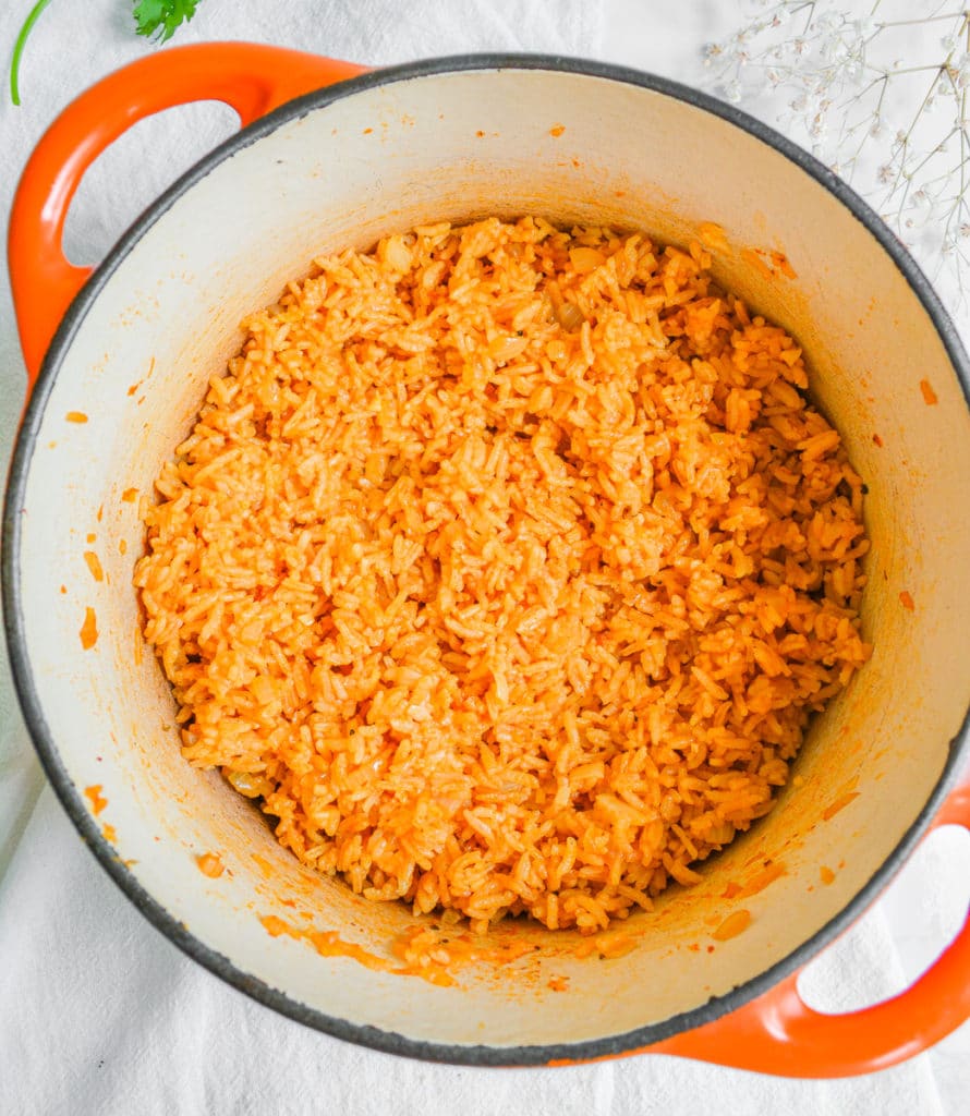 Cooked rice in an orange dutch oven