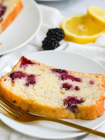 A slice of Blackberry Lemon Bread bread on a white plate
