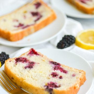 Close up of blueberry lemon bread slice on a white plate