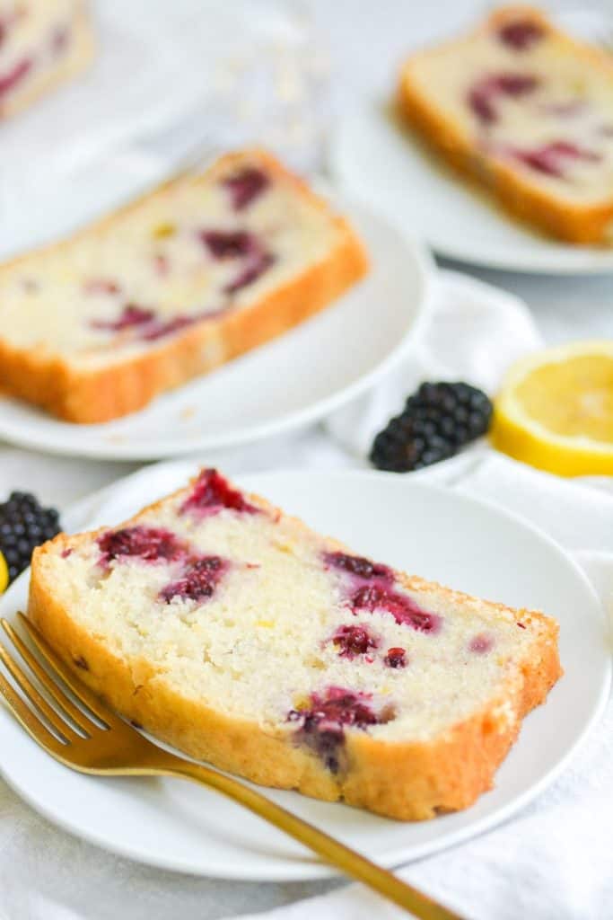 Close up of blueberry lemon bread slice on a white plate